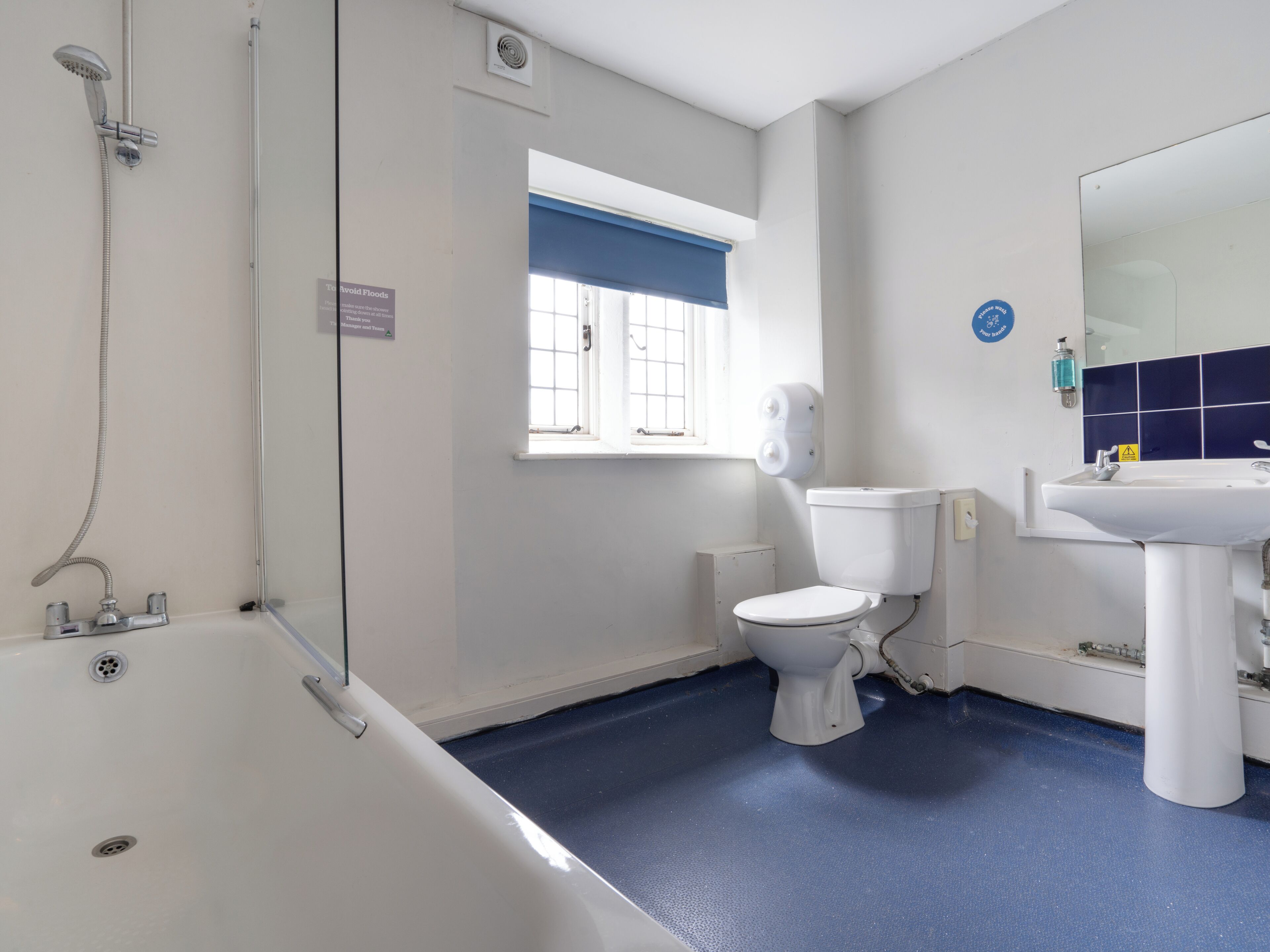 A bathroom with a bathtub, toilet, and sink.