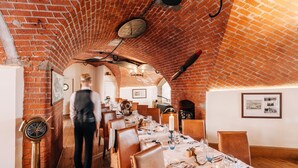 A restaurant with brick walls, wooden tables, and chairs. - No Man's Fort (Portsmouth)