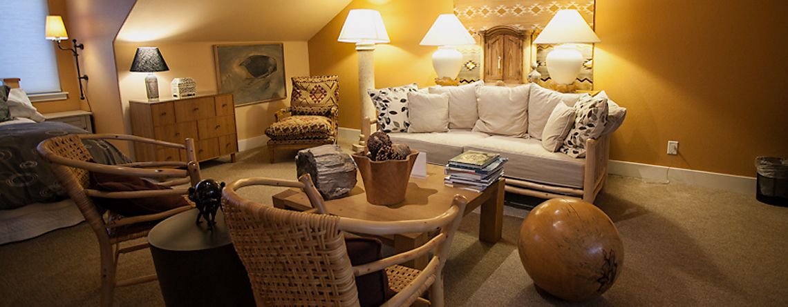 A cozy living room with a sofa, chairs, a coffee table, and lamps.