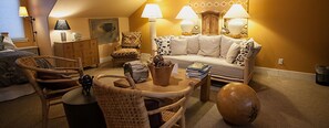 A cozy living room with a sofa, chairs, a coffee table, and lamps.