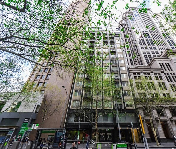 A multi-story building with a modern architectural design, featuring a mix of glass and concrete facades. - Anchor on Collins (Melbourne)