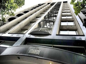 A modern building with multiple balconies and a sign reading "The MARK". - Anchor on Collins (Melbourne)