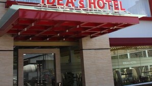 A hotel with a modern facade, featuring a prominent red and white sign that reads "IDEA'S HOTEL". - Idea's Hotel (Bandung)