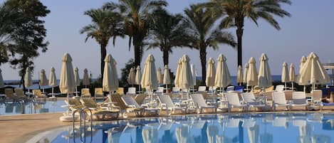 2 outdoor pools, open 7:00 AM to 8:00 PM, pool umbrellas, pool loungers