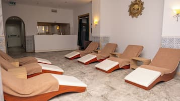 A spa area with multiple wooden loungers, a reception desk, and a shower area.