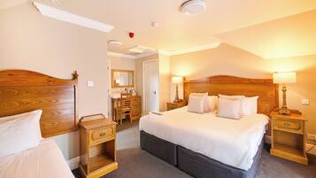 Desk, iron/ironing board, bed sheets