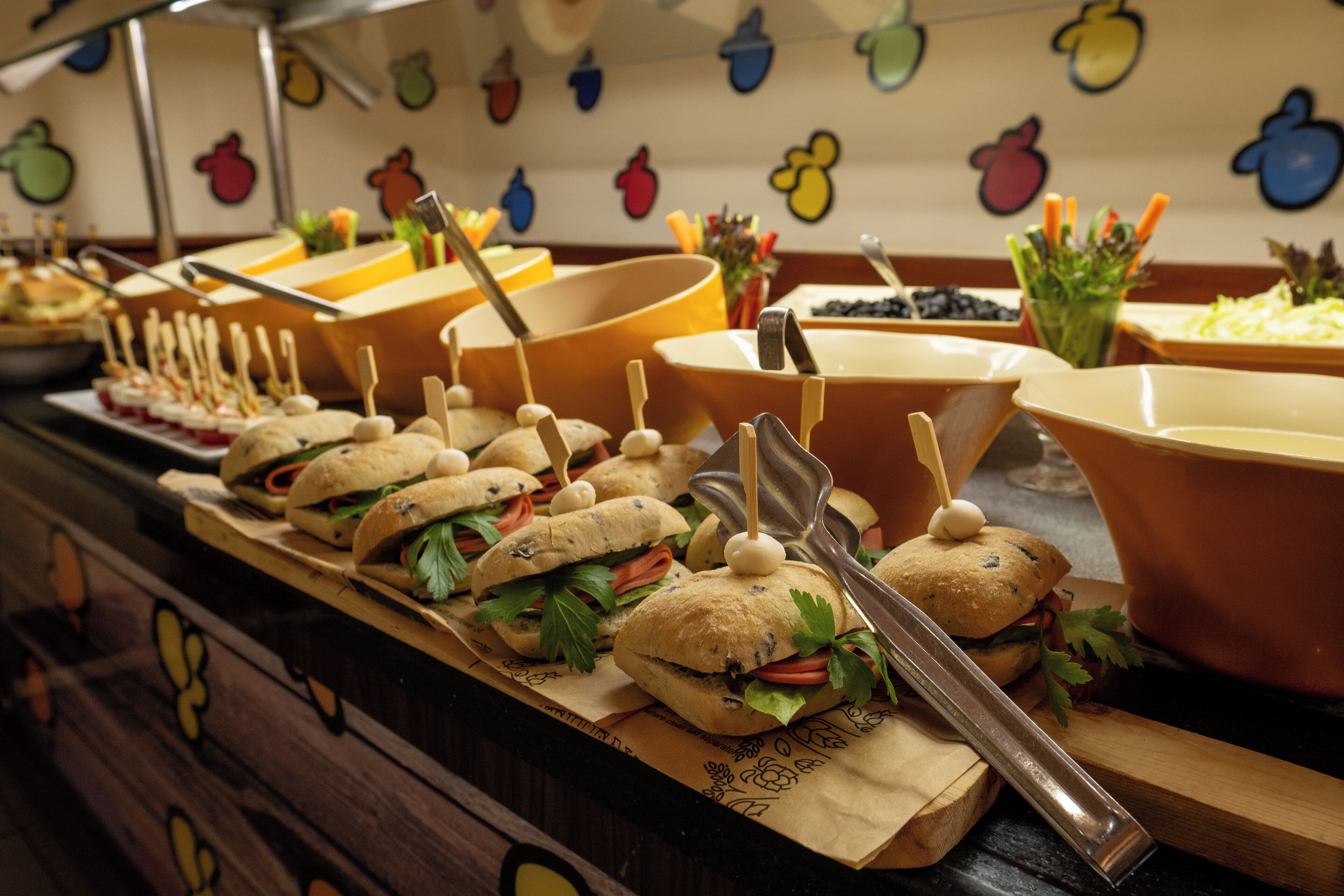 Un bufé con diversos alimentos y utensilios para servir.