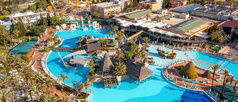 A resort with a large central pool, multiple smaller pools, and a variety of lounge areas.