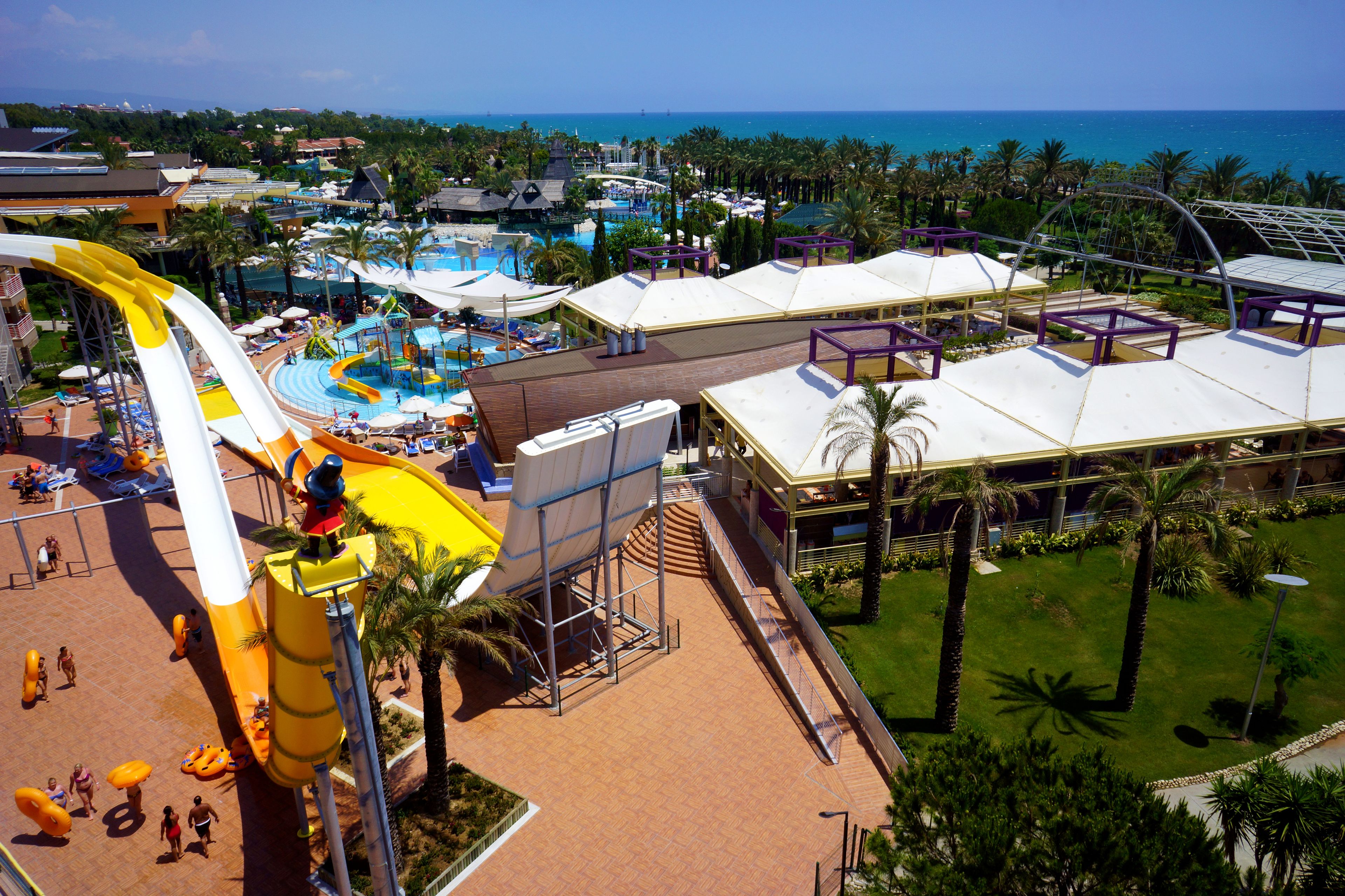 A resort with a water park, including a large water slide and a pool area.