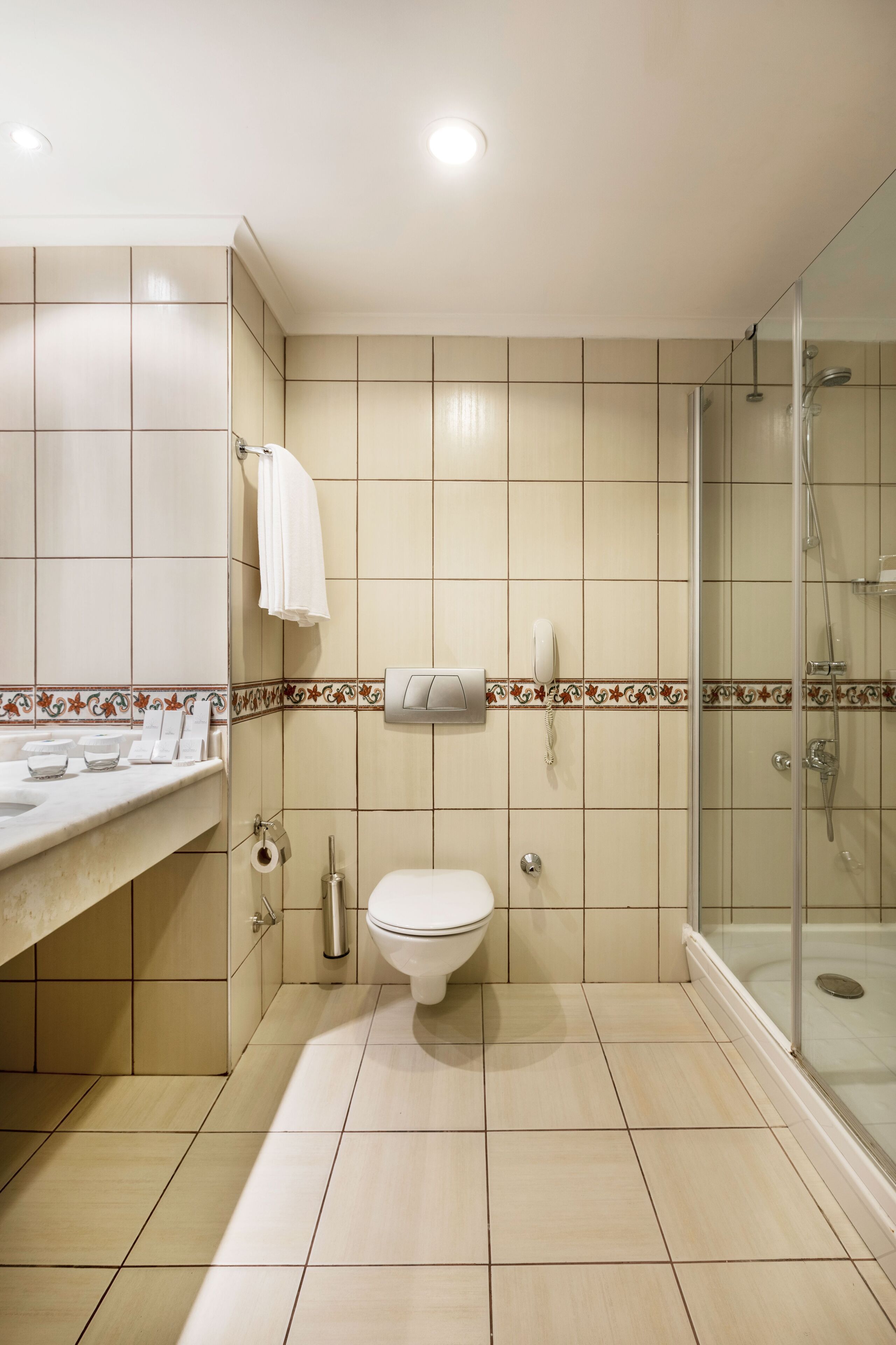 A bathroom with a toilet, sink, and shower.
