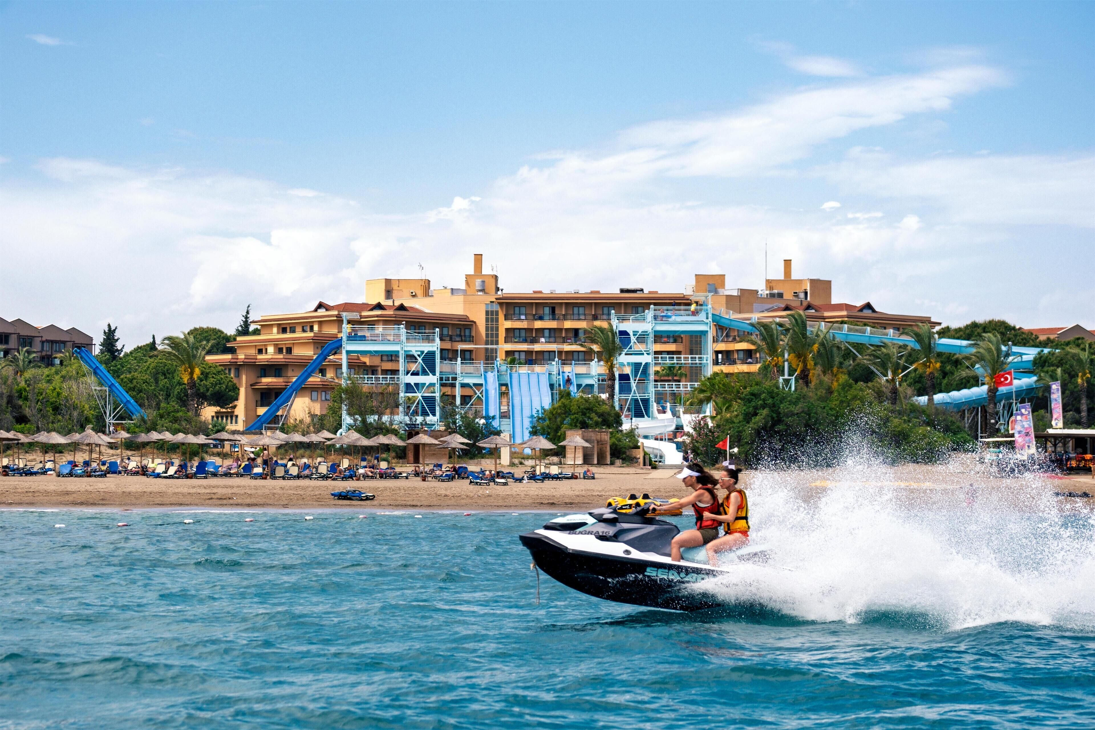 A water jet ski on a beach with a resort building in the background.