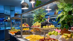 A buffet with various fruits and vegetables displayed in bowls and plates. - Asteria Family Resort Belek (Ex. Aquaworld Belek) - All inclusive (Serik)