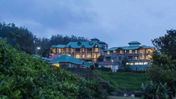A large, multi-story building with a traditional architectural style, surrounded by lush greenery. - Heaven Seven Nuwara Eliya (Nuwara Eliya)