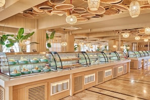 Een buffetgedeelte met meerdere vitrines, houten lambrisering en hangende wilgentaklampen.