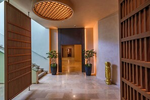 A hallway with a wooden floor, a staircase, and two potted plants. - Corendon Hydros Club Kemer (Kemer)