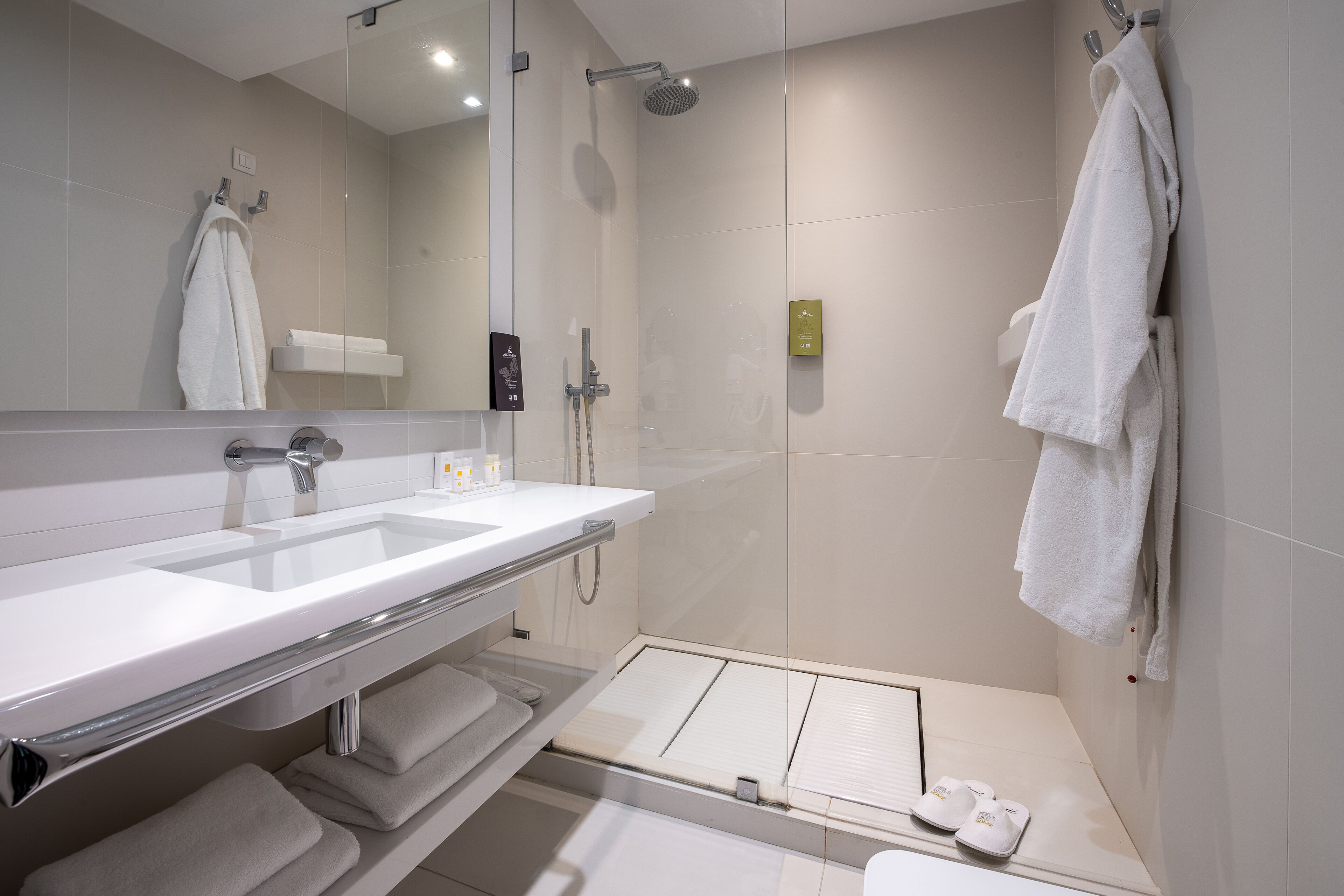 designer toiletries, hair dryer, bathrobes, slippers