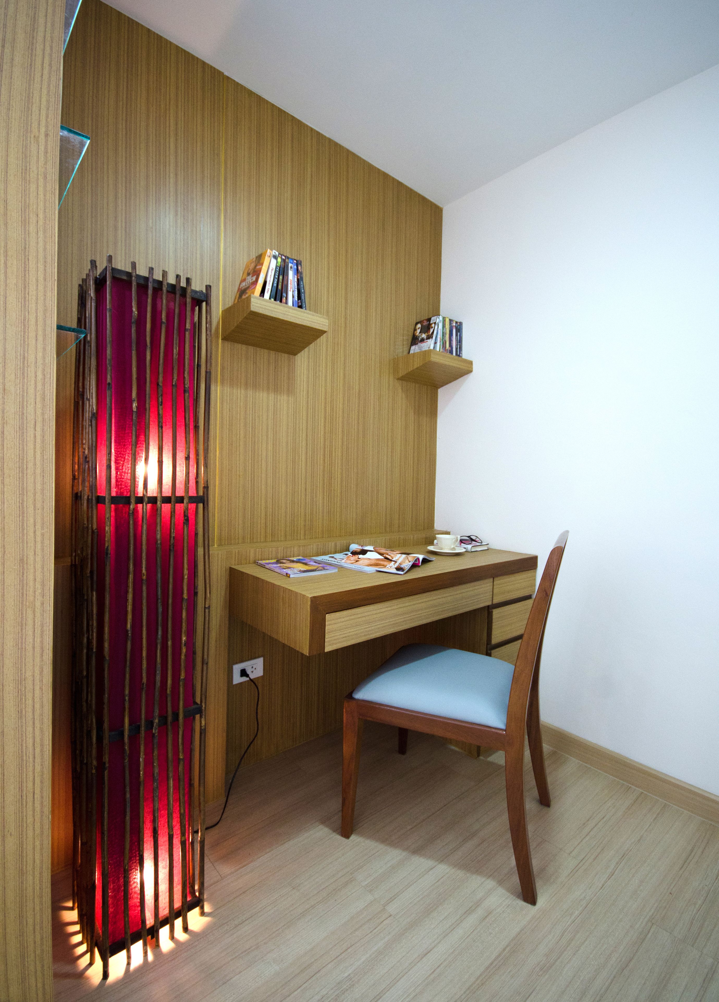 A compact room with a wooden desk, a chair, and two bookshelves.