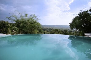 Outdoor pool, an infinity pool, open 7:00 AM to 8:00 PM, pool umbrellas