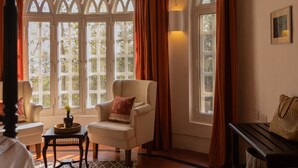 A room with a large window, a wooden ceiling, and a patterned rug. - Wildflower Villas (Candolim)