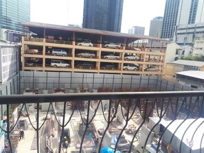A multi-level parking structure with several cars parked on each level. - Bed by City Surawong-Patpong (Bangkok)
