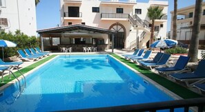 Outdoor pool, pool umbrellas, pool loungers - New York Plaza Hotel Apartments (Paphos)