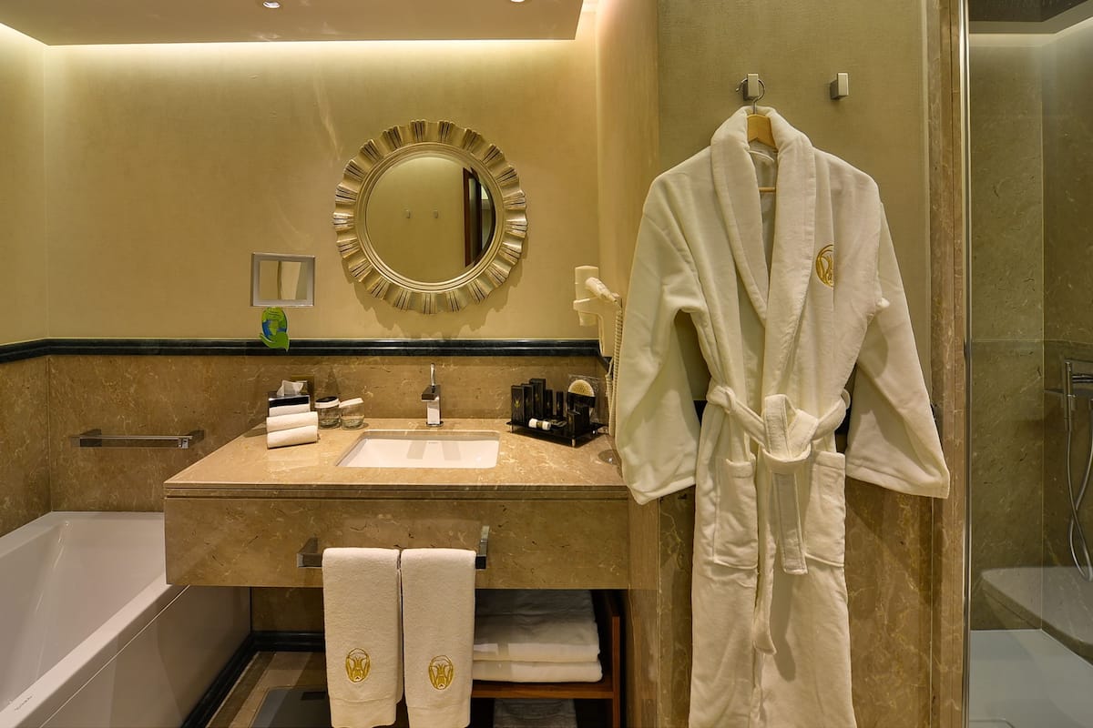 royal suite | bathroom | rainfall showerhead, designer toiletries, hair dryer, slippers