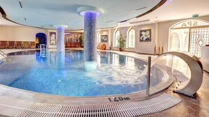 An indoor swimming pool with a 1.6m depth, surrounded by a tiled deck and a glass barrier. - Suhan Cappadocia Hotel & Spa (Avanos)