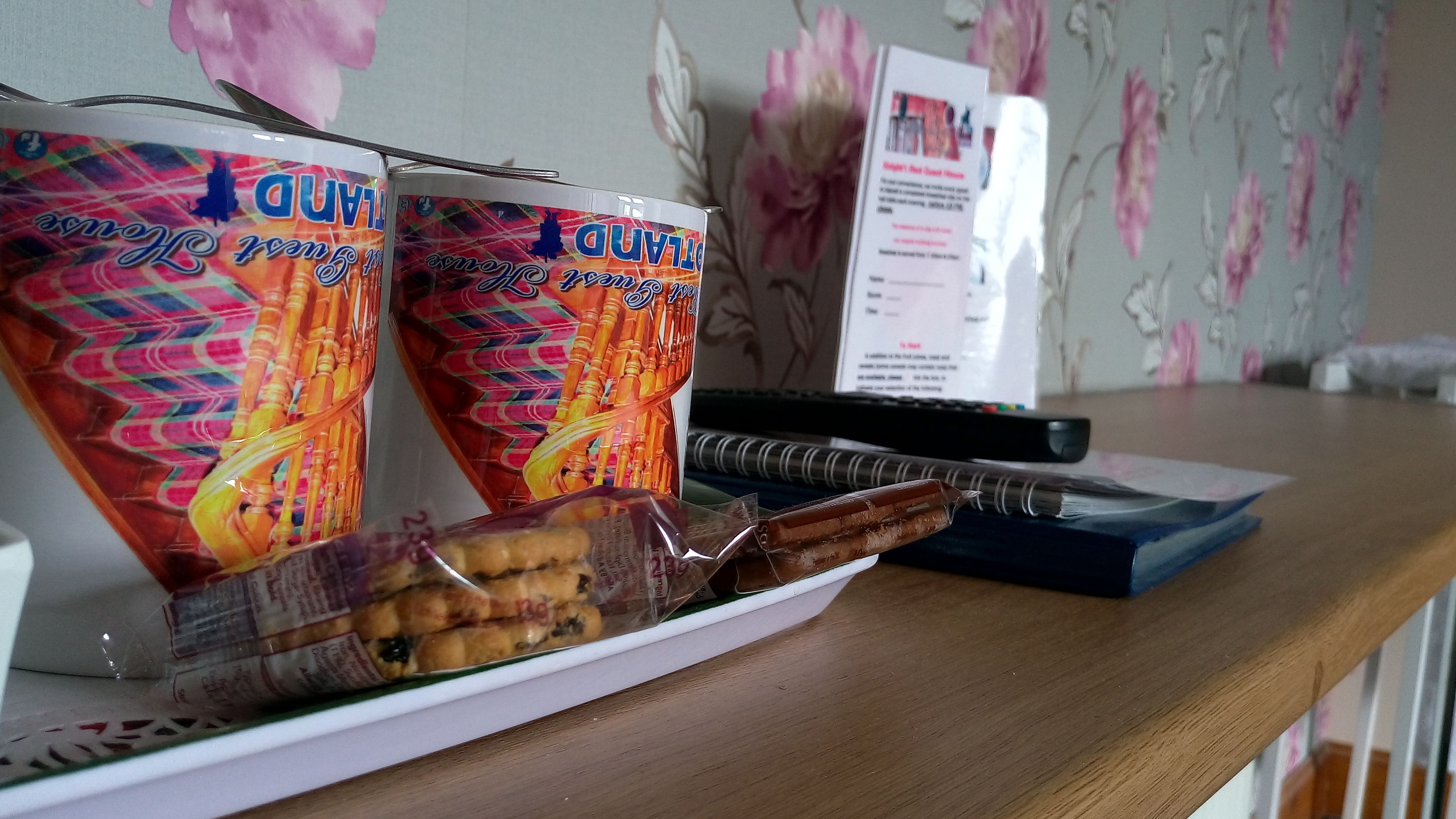 A desk with a tray containing two cans of 'Duvet' and a packet of biscuits.