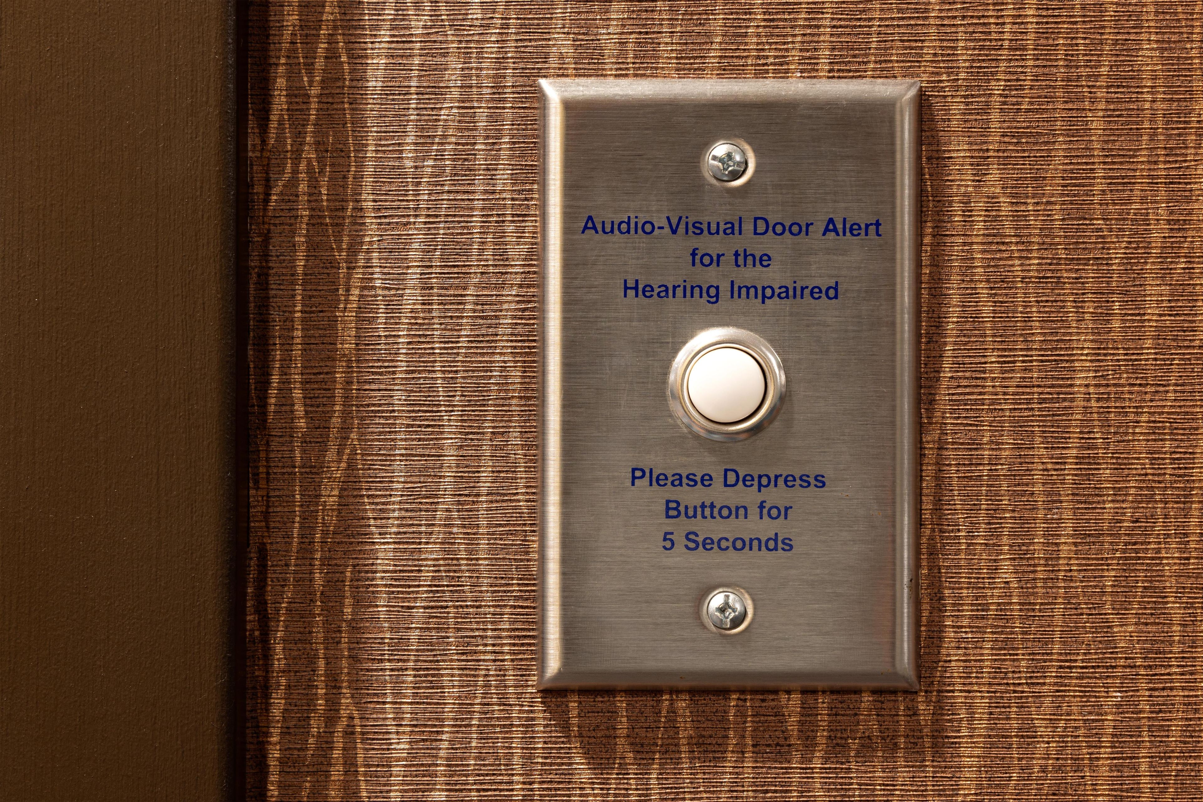 A door with an audio-visual alert system for the hearing impaired, including a depress button for 5 seconds.