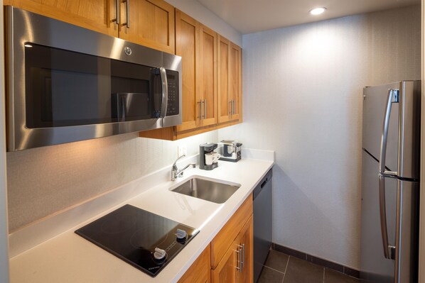 A modern kitchen with stainless steel appliances, a double sink, and wooden cabinets. - Homewood Suites by Hilton Seattle-Issaquah (Issaquah)
