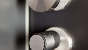 A close-up of a metallic door handle with a modern design.