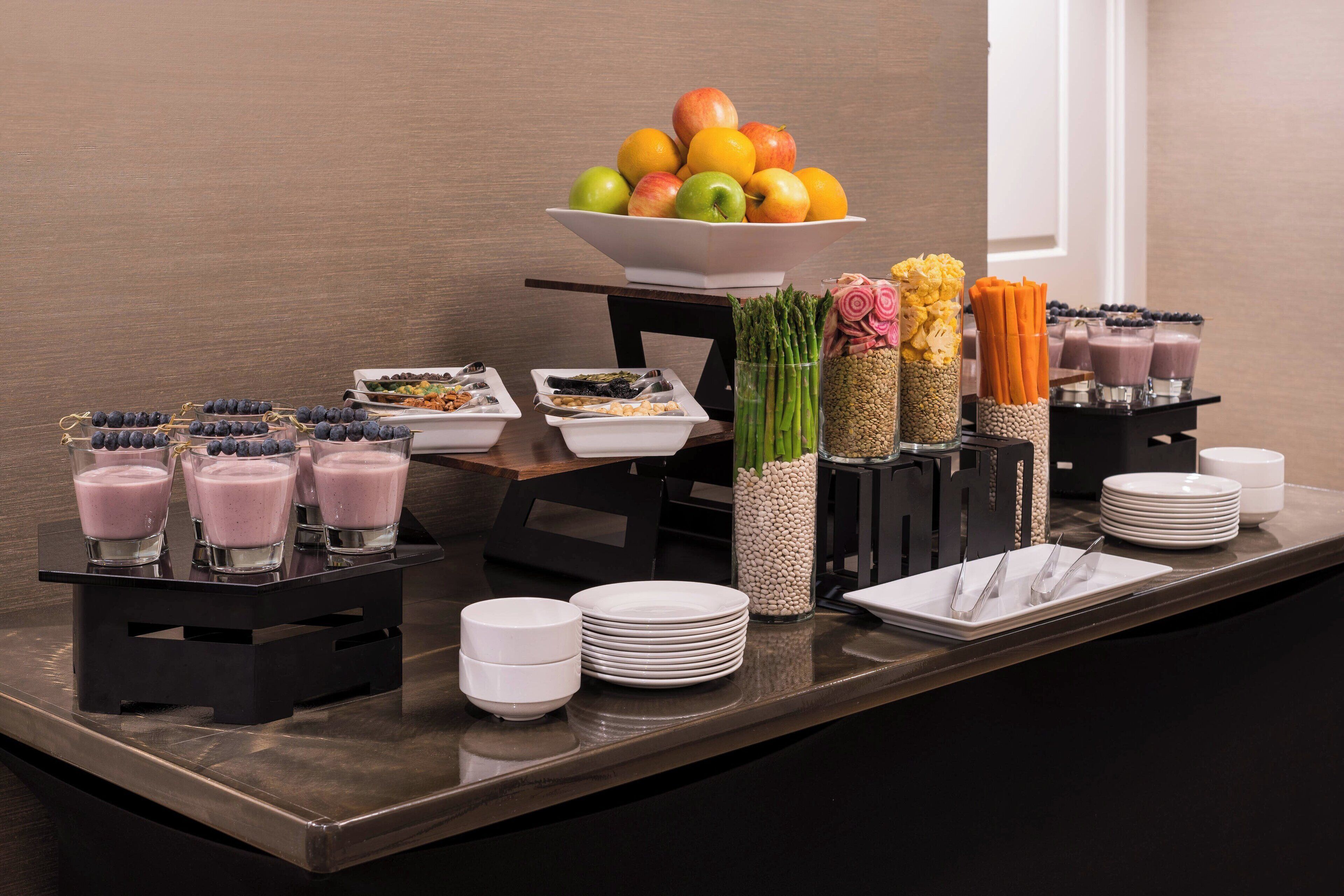 A buffet setup with various food items and drinks.