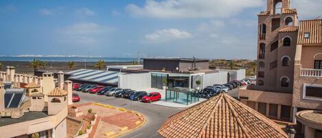 Un hôtel doté d’un bâtiment moderne et d’une tour de style traditionnel, d’un parking et offrant une vue sur la mer.