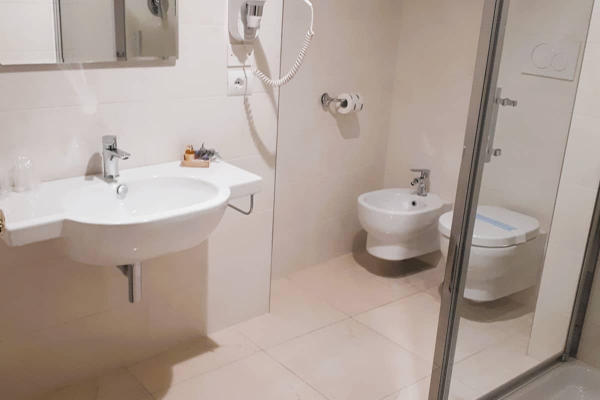 luxury suite | bathroom | shower, free toiletries, hair dryer, slippers
