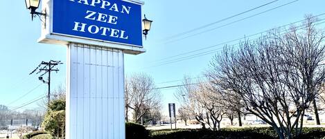 A Tappan Zee Hotel sign with a blue background and white lettering.
