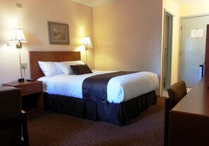 Relax in a cozy space with a comfortable bed, bedside lamps, and a convenient nightstand.