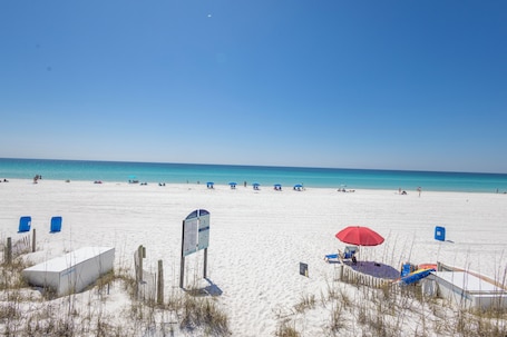 On the beach, white sand, sun-loungers. Sundrift Inn