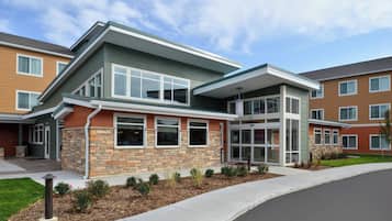 Situated in a well-maintained neighborhood, this two-story building features a flat roof and a covered front porch.