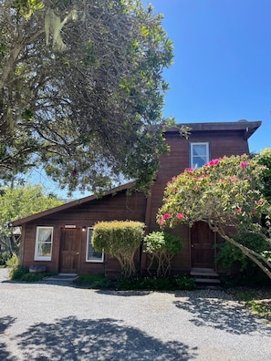 A two-story wooden house with a front porch, a small window, and a door. - Sweetwater Inn and Spa (Mendocino)