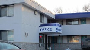 A building with a sign that reads "OFFICE Sleep" indicating a business or office building with sleeping accommodations.