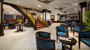 A spacious lobby with a grand staircase, comfortable seating, and a chandelier. - Vientiane Golden Sun Hotel & Spa (Vientiane)