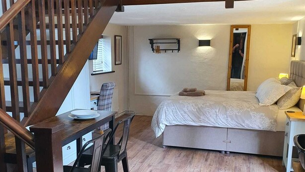 A bedroom with a bed, a desk, and a chair. - The Lower Bell (Aylesford)