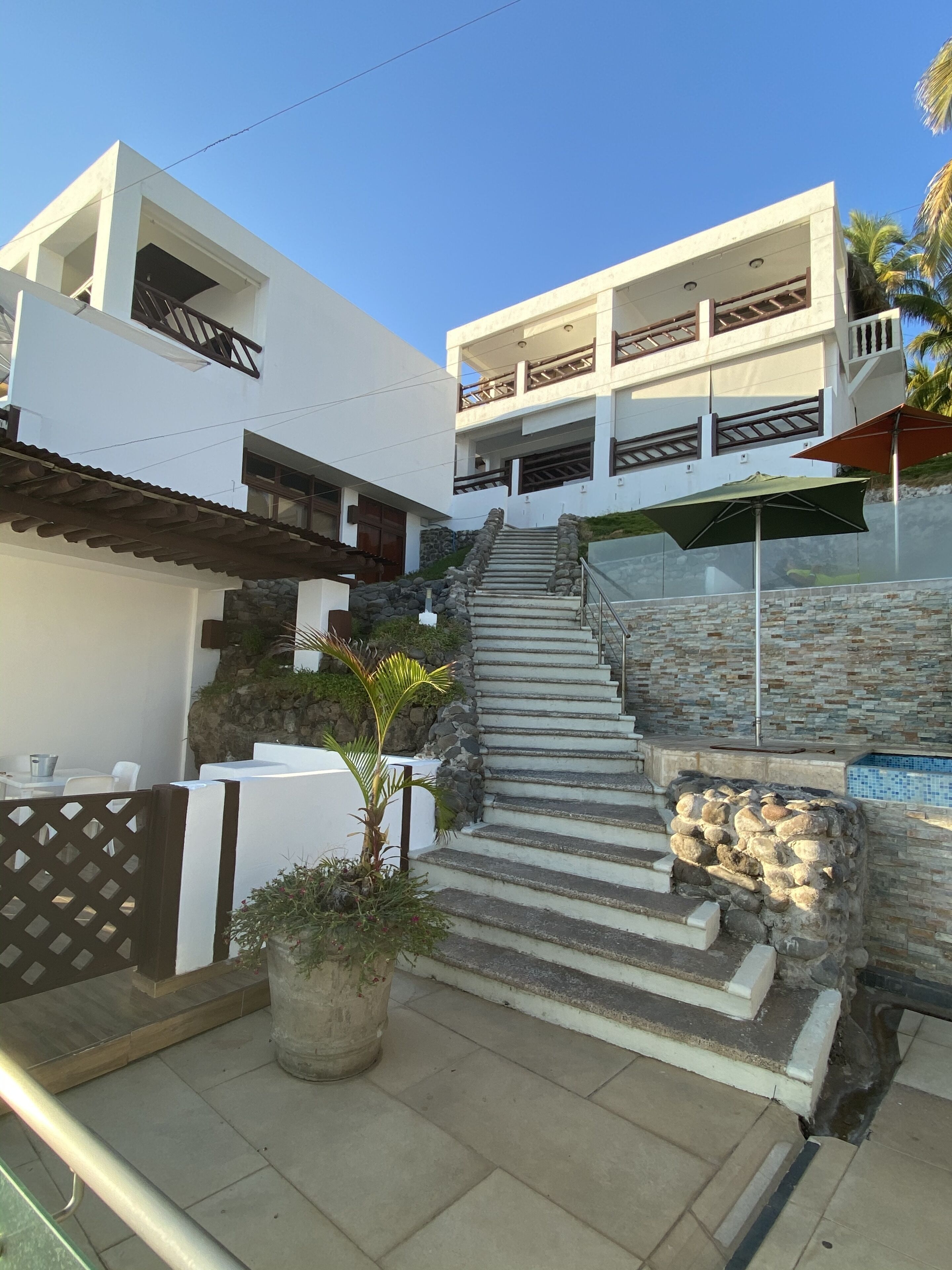 A modern building with a staircase leading to a balcony.
