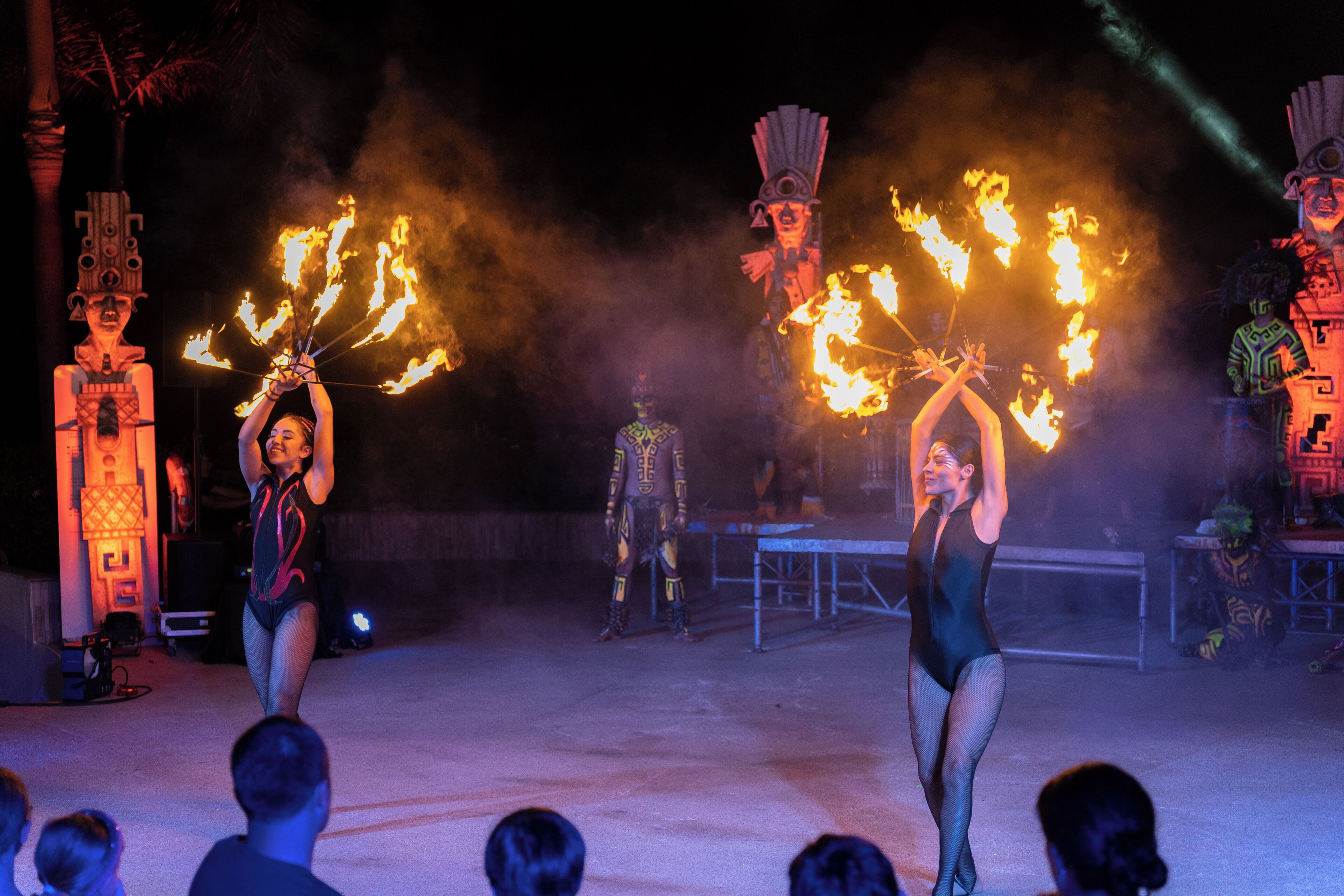 A performance with fire props and performers in costumes.