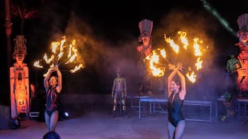 A performance with fire props and performers in costumes.