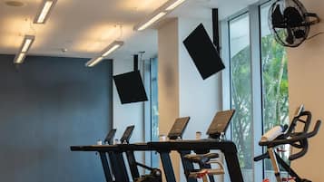 A gym with treadmills, an elliptical, and a stationary bike.