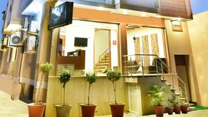 A hotel with a vertical sign reading "Hotel Jupiter" and a staircase leading to the entrance. - Hotel Sapphire (Amritsar)
