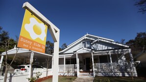 A house with a porch and a sign advertising a breakfast option. - Sunny Side Up B&B (Rye)