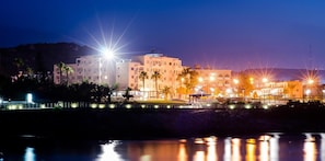 A coastal hotel with multiple buildings, a waterfront promenade, and palm trees. - Astreas Beach Hotel (Paralimni)