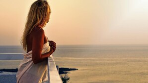 A person standing by a railing overlooking a vast landscape. - Astreas Beach Hotel (Paralimni)